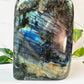 freeform blue flash large labradorite on white marble with leaves and flowers