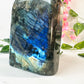 freeform blue flash large labradorite on white marble with leaves and flowers