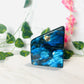 freeform blue flash large labradorite on white marble with leaves and flowers