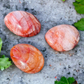 fire quartz palm stones laying on concrete outside