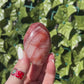 fire quartz palm stones in woman's hand outside. 