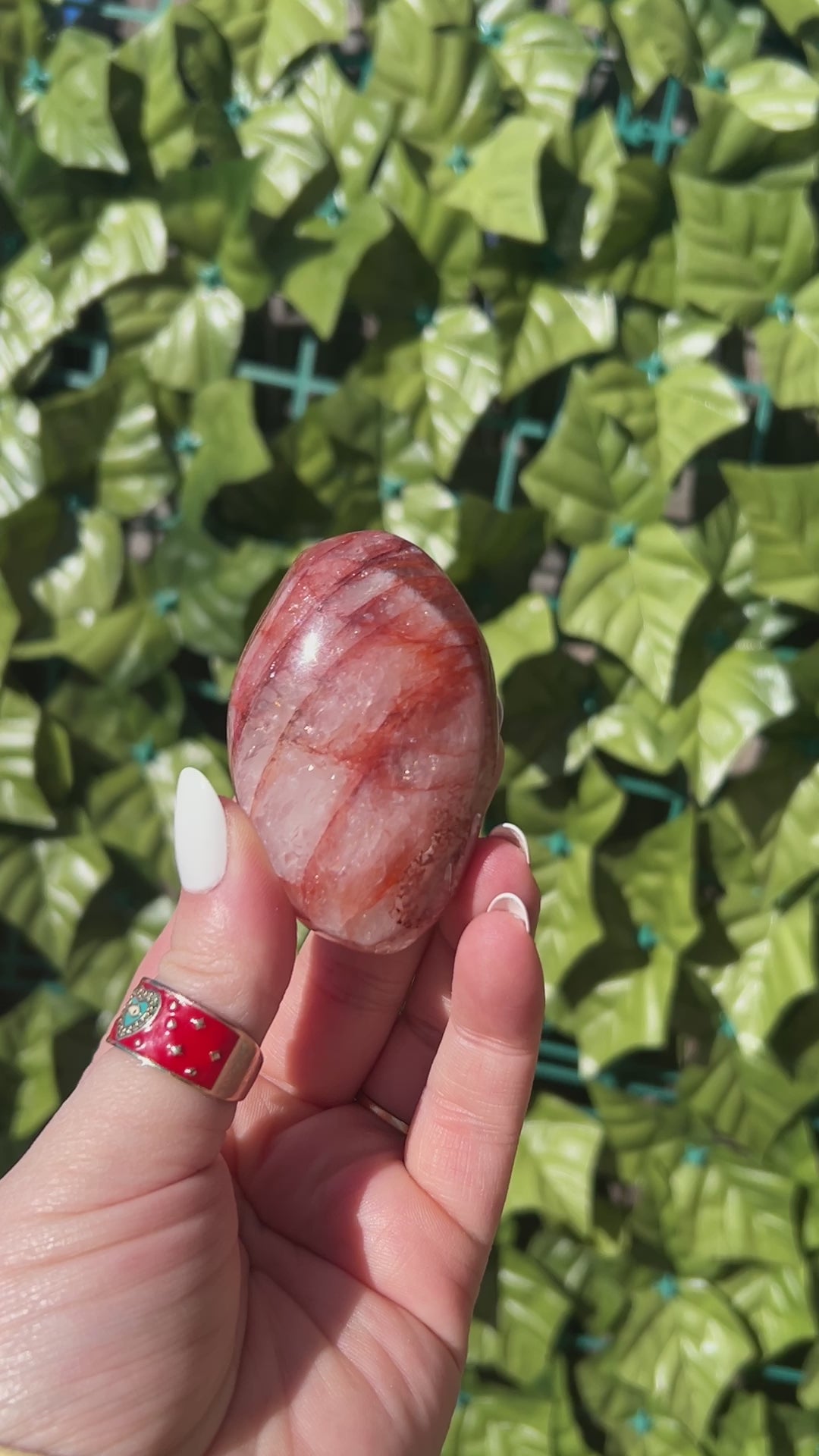 fire quartz palm stones in woman's hand outside. 