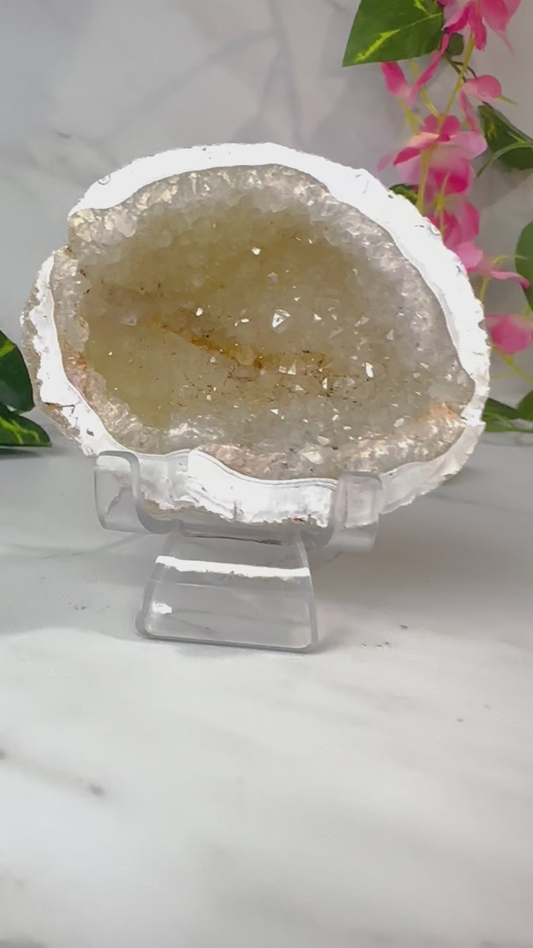 druzy agate geode on marble with leaves and flowers