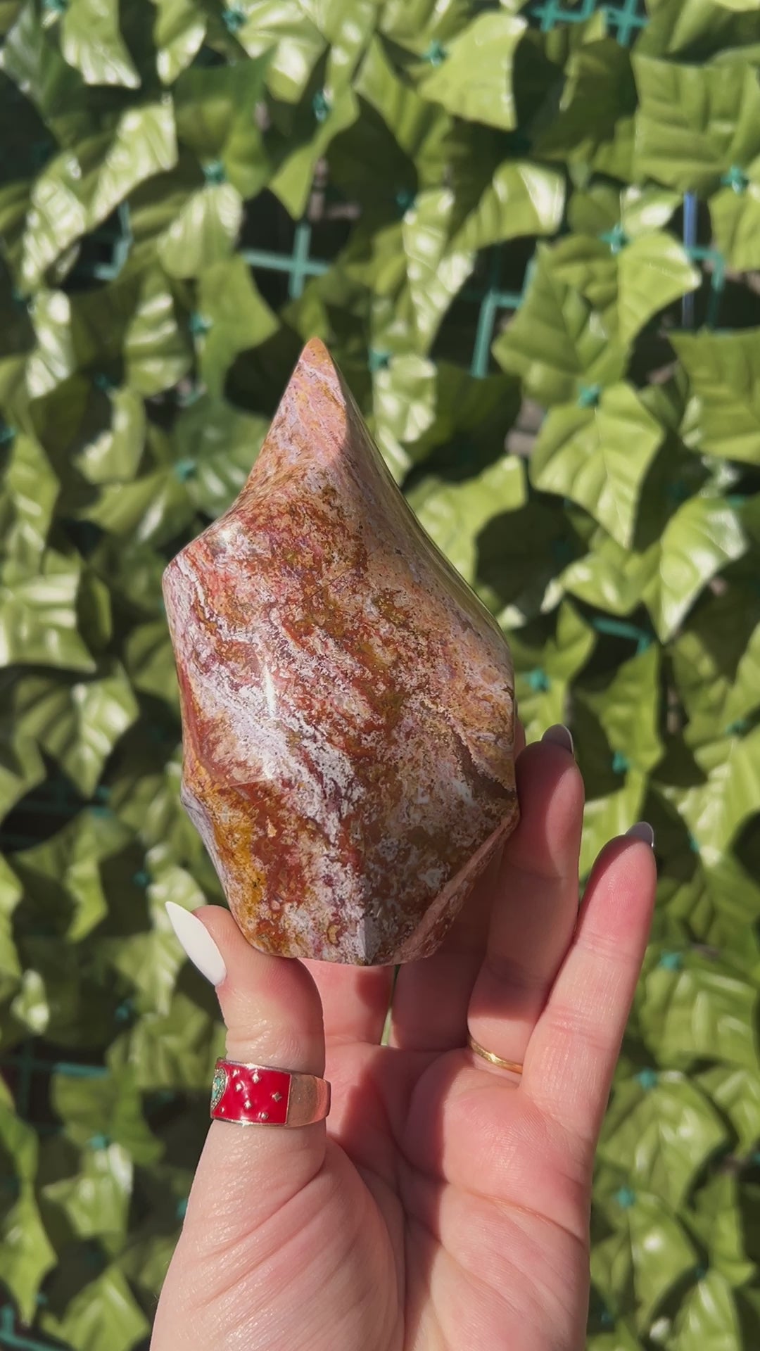 Ocean Jasper Spiral Tower in woman's hand outside