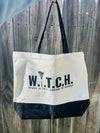 black and white tote bag that says W.I.T.C.H. woman in total control of herself. Hanging on a fence